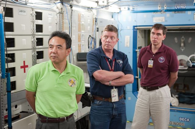 three men standing in a space station - Download Free Stock Photos Pikwizard.com