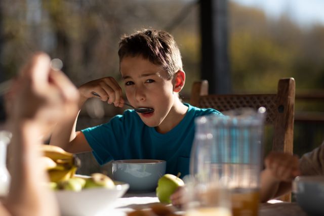 Caucasian boy eating cereal during his breakfast - Download Free Stock Photos Pikwizard.com
