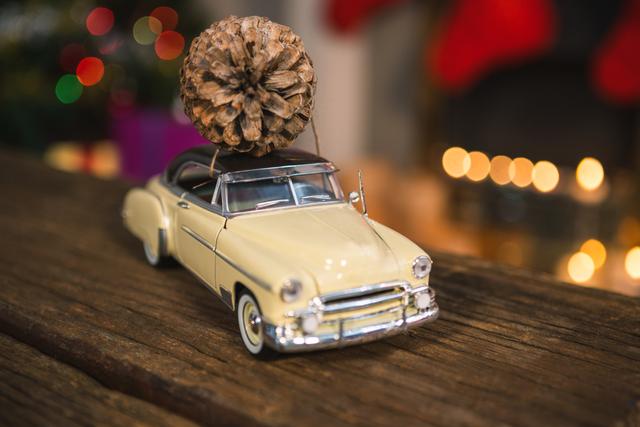 Toy car with pine cone on wooden table - Download Free Stock Photos Pikwizard.com