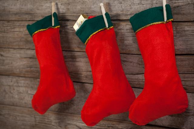 Christmas stocking hanging against wooden wall - Download Free Stock Photos Pikwizard.com