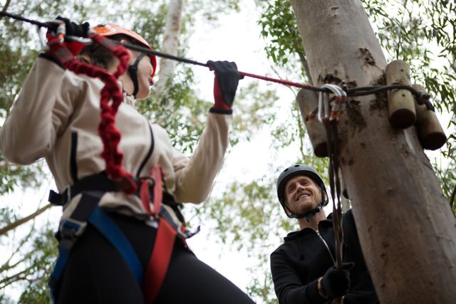 Hiker woman holding zip line in forest during daytime