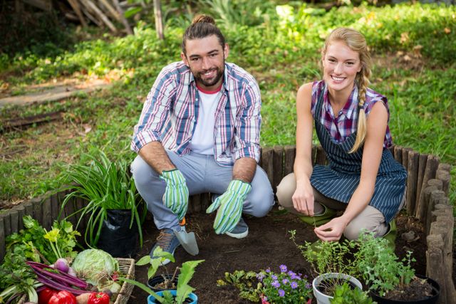 Portrait of happy gardeners with potted plants at garden - Download Free Stock Photos Pikwizard.com