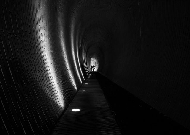 a tunnel with light coming from the end - Download Free Stock Photos Pikwizard.com