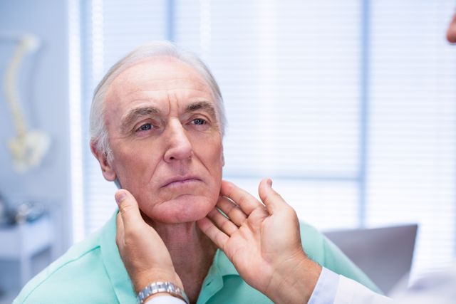Doctor examining senior patients neck - Download Free Stock Photos Pikwizard.com