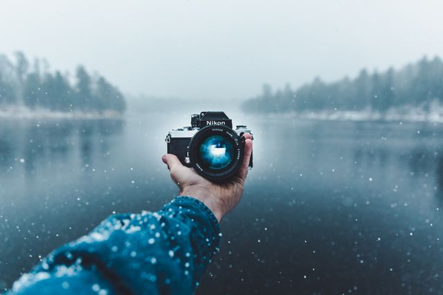 Reflection of Man Photographing in Snow - Download Free Stock Photos Pikwizard.com