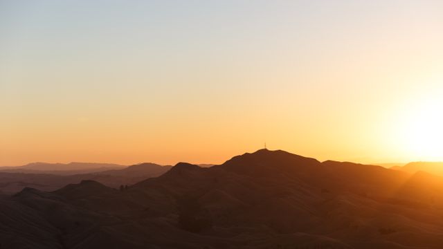 the sun setting over a mountain range - Download Free Stock Photos Pikwizard.com