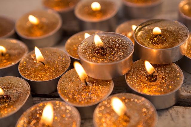 Close-up of candles burning on wooden plank - Download Free Stock Photos Pikwizard.com