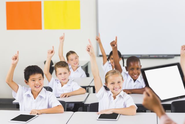 School kids raising hand in classroom - Download Free Stock Photos Pikwizard.com