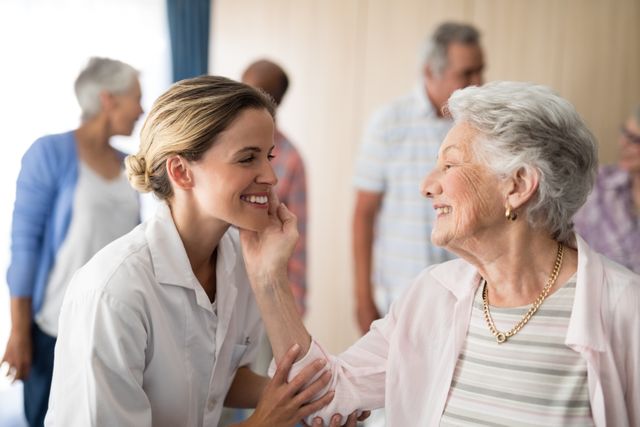 Senior woman touching smiling female doctor - Download Free Stock Photos Pikwizard.com