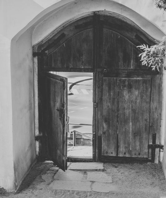 Black and white photo doorway huge doorway leading to street old big wooden door - Download Free Stock Photos Pikwizard.com