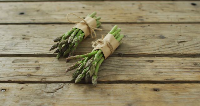 Image of two fresh asparagus bundles on wooden background - Download Free Stock Photos Pikwizard.com