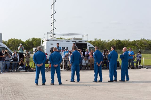 CAPE CANAVERAL, Fla. -- The STS-134 crew members arrived on the Shuttle Landing Facility at NASA's Kennedy Space Center in Florida at about 9 a.m. EDT to get ready for space shuttle Endeavour's launch to the International Space Station scheduled for Monday, May 16 at 8:56 a.m. Facing the media  are from right, Commander Mark Kelly, Mission Specialists Greg Chamitoff, Andrew Feustel, European Space Agency astronaut Roberto Vittori, at the microphone, Michael Fincke and Pilot Greg H. Johnson.          Endeavour and its crew will deliver the Express Logistics Carrier-3, Alpha Magnetic Spectrometer-2 (AMS), a high-pressure gas tank and additional spare parts for the Dextre robotic helper to the station. This will be the final spaceflight for Endeavour. For more information visit, www.nasa.gov/mission_pages/shuttle/shuttlemissions/sts134/index.html. Photo credit: NASA/Kim Shiflett