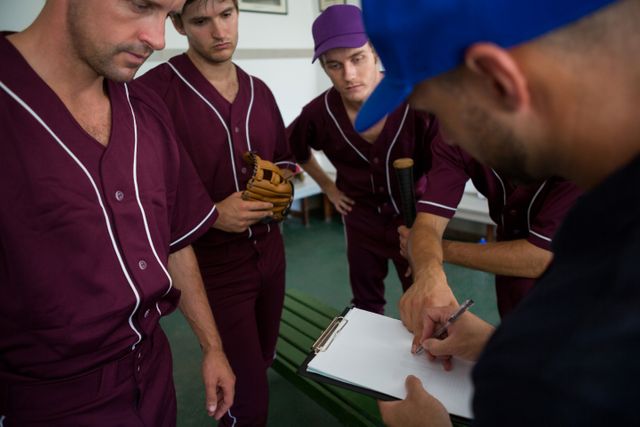 Close up of baseball team planning with coach - Download Free Stock Photos Pikwizard.com