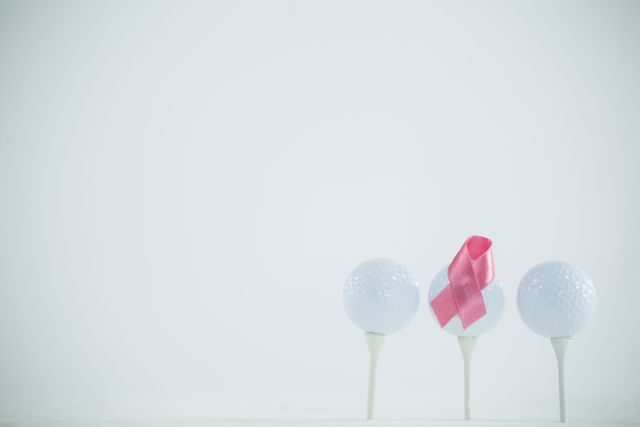 Pink Breast Cancer Awareness ribbon on golf ball - Download Free Stock Photos Pikwizard.com