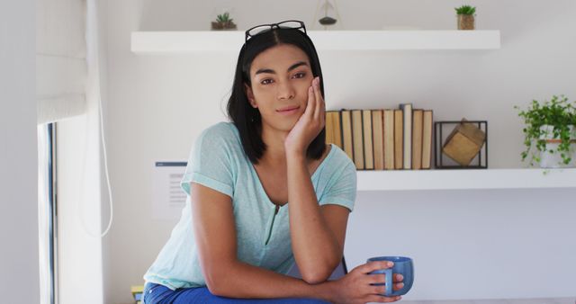Portrait of mixed race gender fluid person looking at camera and smiling at home - Download Free Stock Photos Pikwizard.com