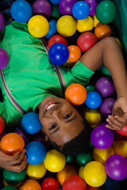 Overhead view of happy boy in ball pool - Download Free Stock Photos Pikwizard.com