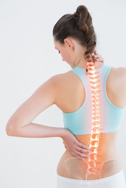 Rear view of woman suffering from pain against white background