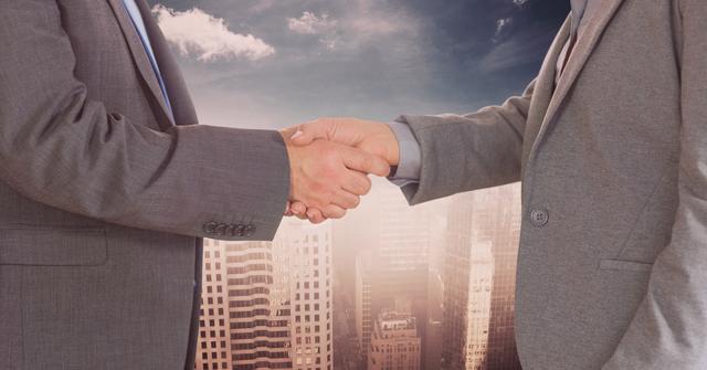 Midsection of businessmen doing handshake against city - Download Free Stock Photos Pikwizard.com