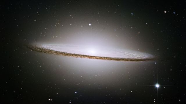 a galaxy with a bright white disk - Download Free Stock Photos Pikwizard.com