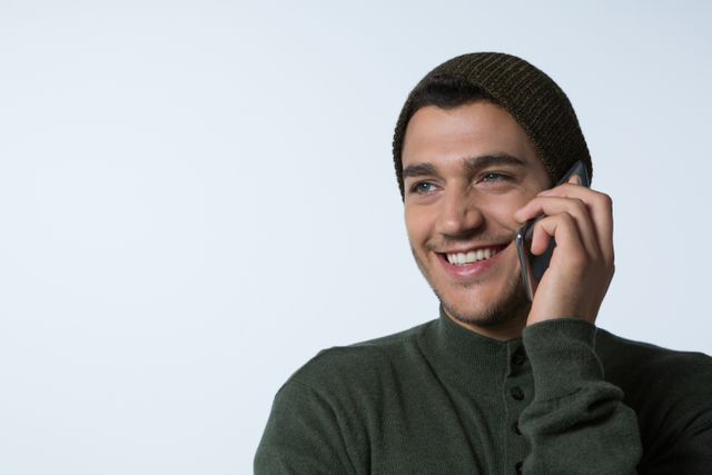 Portrait of smiling young man ironing cloth in kitchen from Pikwizard