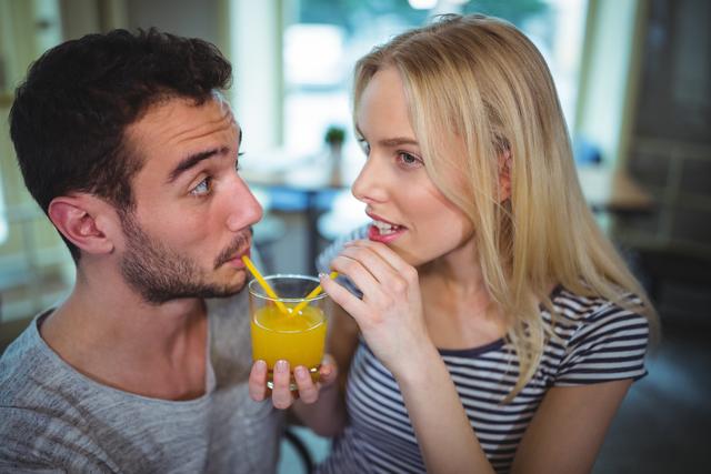 Couple having a glass of orange juice - Download Free Stock Photos Pikwizard.com