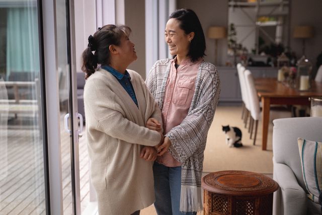 Two asian senior woman standing and talking at home - Download Free Stock Photos Pikwizard.com