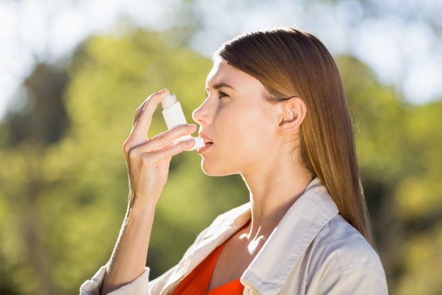 Woman using asthma inhaler - Download Free Stock Photos Pikwizard.com