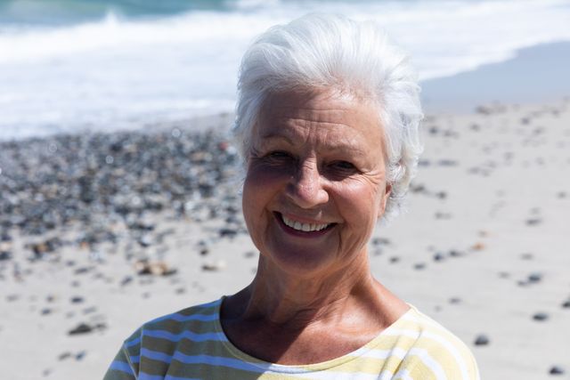 Portrait of happy senior caucasian woman smiling at the beach - Download Free Stock Photos Pikwizard.com