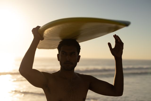 Man standing with surfboard on the beach - Download Free Stock Photos Pikwizard.com
