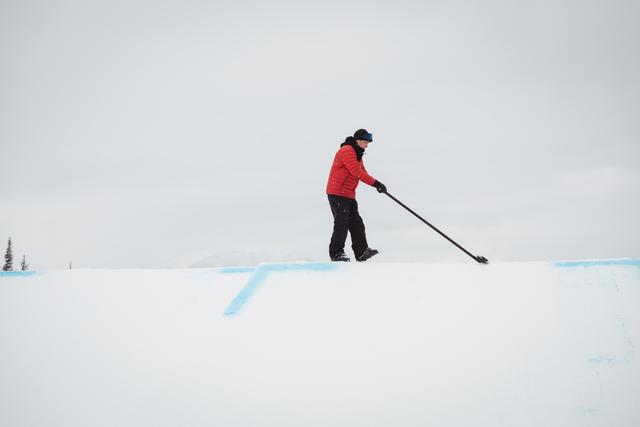 Man cleaning snow in ski resort - Download Free Stock Photos Pikwizard.com