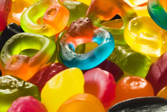 High angle full frame view of multi colored sugar candies heap. unaltered, unhealthy eating and sweet food concept.