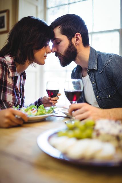 Couple romancing while having wine and breakfast - Download Free Stock Photos Pikwizard.com