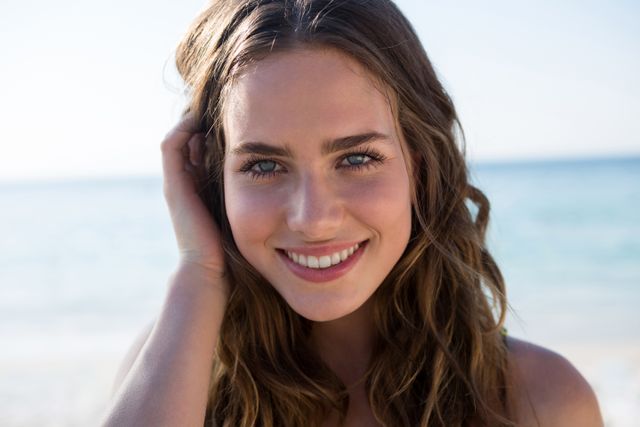Portrait of smiling beautiful woman at beach - Download Free Stock Photos Pikwizard.com