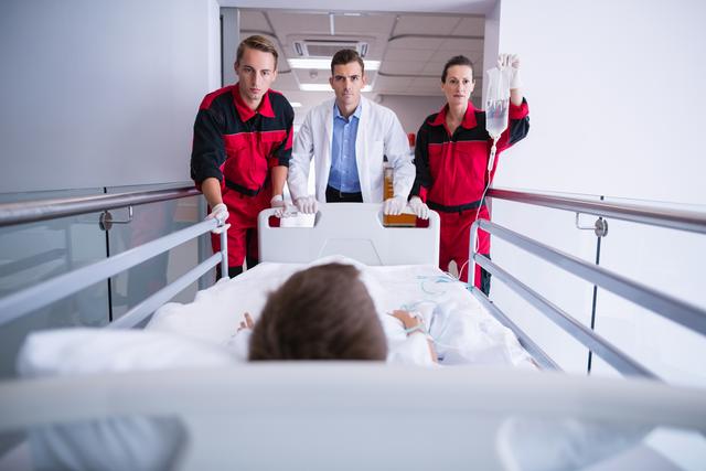 Doctors pushing emergency stretcher bed in corridor- Download Free Stock Photos Pikwizard.com