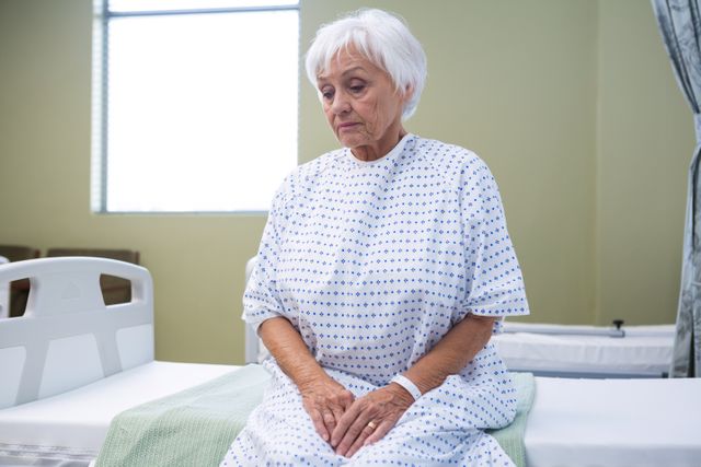 Worried senior patient sitting on bed - Download Free Stock Photos Pikwizard.com