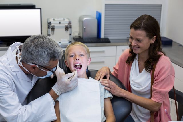 Dentist examining young patient with dental tool - Download Free Stock Photos Pikwizard.com