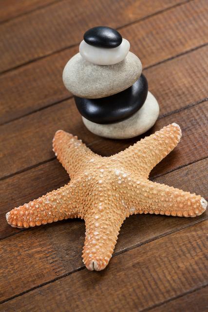Pebble stones with star fish on a table