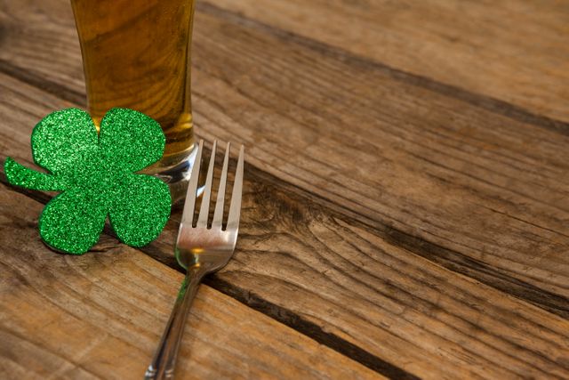 Glass of beer, fork and shamrock for St Patricks Day - Download Free Stock Photos Pikwizard.com