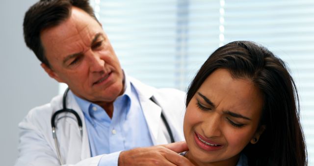 A doctor attentively examines a patient's painful shoulder, highlighting medical diligence. - Download Free Stock Photos Pikwizard.com