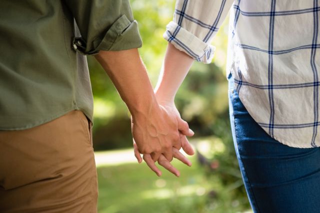Mid-section of couple holding hands - Download Free Stock Photos Pikwizard.com