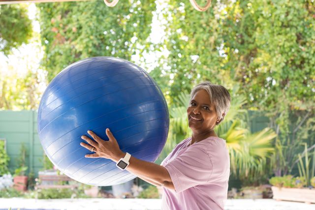 Portrait of woman holding fitness ball - Download Free Stock Photos Pikwizard.com