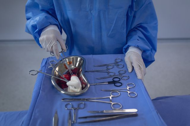 Surgeon holding surgical scissor in operation theater at hospital - Download Free Stock Photos Pikwizard.com