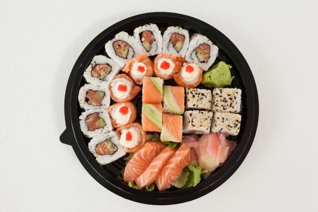 Set of assorted sushi kept in a round black box - Download Free Stock Photos Pikwizard.com
