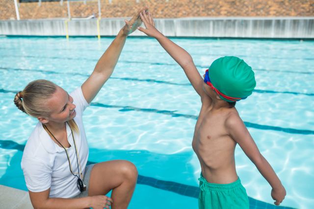 Female trainer training a boy for swimming - Download Free Stock Photos Pikwizard.com