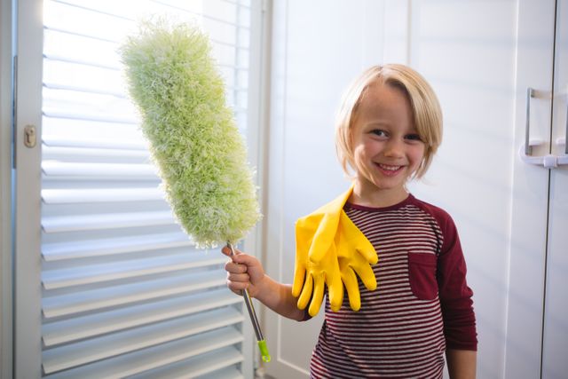 Boy holding a mop at home - Download Free Stock Photos Pikwizard.com