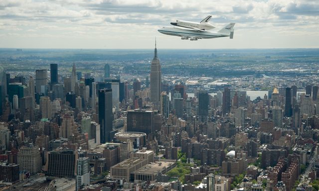 Space shuttle Enterprise, mounted atop a NASA 747 Shuttle Carrier Aircraft (SCA), is seen as it flies near the Empire State Building, Friday, April 27, 2012, in New York. Enterprise was the first shuttle orbiter built for NASA performing test flights in the atmosphere and was incapable of spaceflight. Originally housed at the Smithsonian's Steven F. Udvar-Hazy Center, Enterprise will be demated from the SCA and placed on a barge that will eventually be moved by tugboat up the Hudson River to the Intrepid Sea, Air & Space Museum in June. Photo Credit: (NASA/Robert Markowitz)