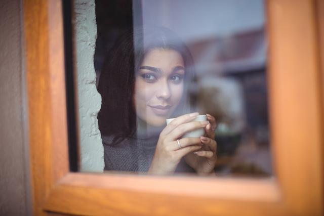 Thoughtful woman having a cup of coffee in cafÃ©