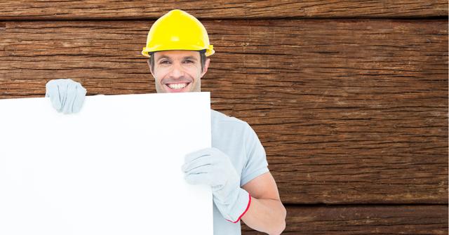 Worker wearing hardhat while holding bill board - Download Free Stock Photos Pikwizard.com