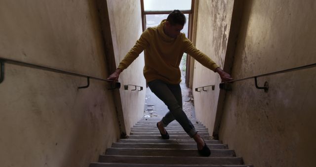 Caucasian male dancer dancing in abandoned staircase, copy space - Download Free Stock Photos Pikwizard.com