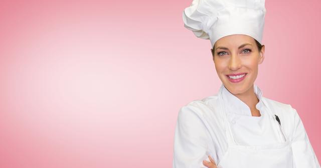Female chef standing with arms crossed against pink background - Download Free Stock Photos Pikwizard.com